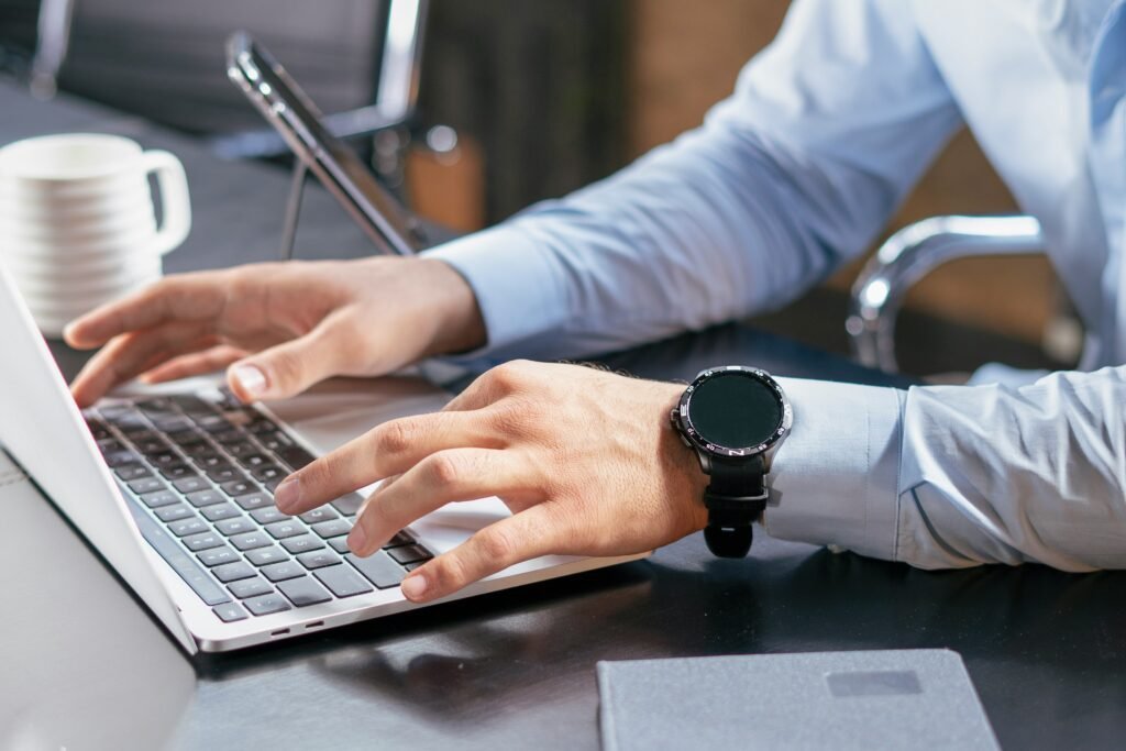 A MAN WORKING ON HIS LAPTOP